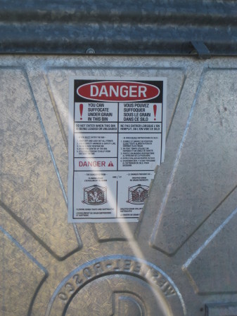 The warning on a grain bin.  Grain engulfment still claims a few lives every couple of years