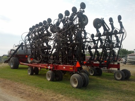 This is an airdrill that plants a 100-foot wide path.  It is followed by a compressor and seed trailer.  You can see the big manifolds that send pipe out to each planter... I forget how much pipe there is in this thing, but more than you think.  ;) 