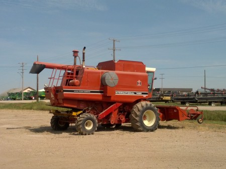 This is an old-school combine, from the days when 'combining' (reaping, threshing, and winnowing) was not done in an air-conditioned cab with satellite radio and GPS-aided tracking. 