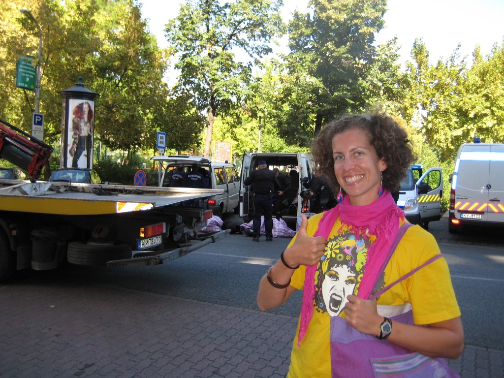 Catherine at â€˜Budapest prideâ€™. Notice the busload of riot police in SWAT gear in the background