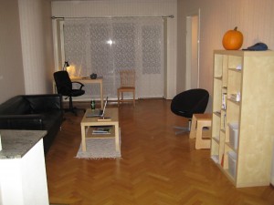 Our 'new' living room, now with chair and sofa!  Also, Check out the farmer's market pumpkin.  I got that for Thanksgiving, part for pie (which Graham's likes) and part for soup (which I like).