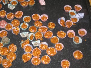 Once the knÃ¤ck reaches the perfect (very hot) temperature it gets spooned (very carefully) into tiny paper cups.  Catherine got to help with this difficult job but for my own safety I continued rolling cookies...