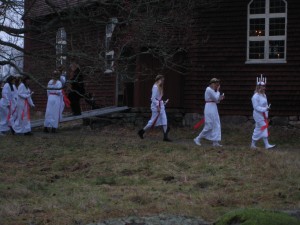 A somewhat less practiced Luciataget at Skansen.  They are walking to the altar-entrance of the church since there is probably a standing-room only crowd.