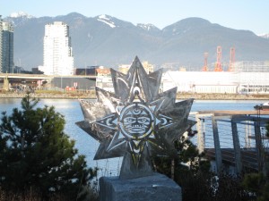 This shows a new west-coast-vibe sculpture by the Athletes village in Vancouver. Through the cutouts you can see False Creek, a glimpse of Olympic tents in Chinatown and past that to the mountains. 