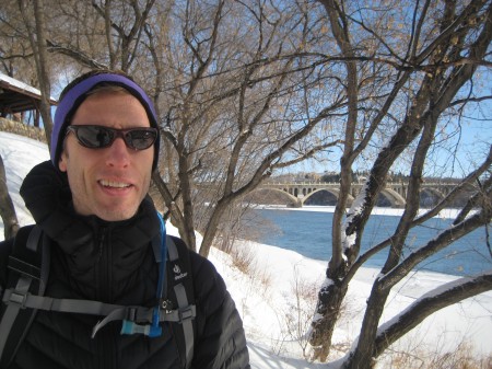 Snowshoeing by the river with the University Bridge in the background