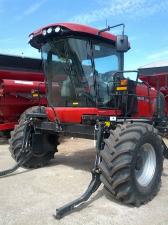 This is a swather, without the swathing head.  It's job is to cut off canola or grain at the ground, then pile it up in rows for drying.  Sometimes this step is skipped and instead farmers spray a dessicant to dry the grain instead, then combine it straight.  