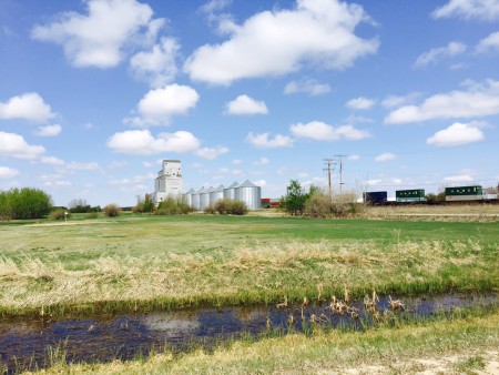 Classic SK scene: grain bins, old wooden grain elevator, and a train (which we had to wait for as our route crossed the tracks minutes after this photo was taken).