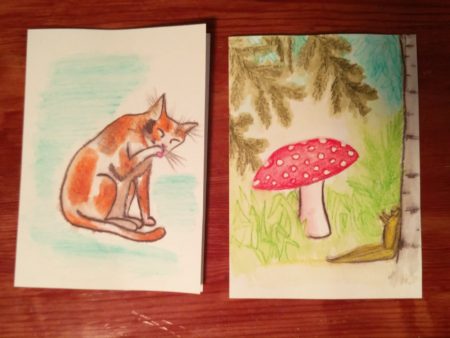 A paw-licking kitty and a toadstool with banana slug