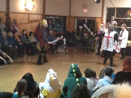 Unicorn and dino in the audience of a mummers play